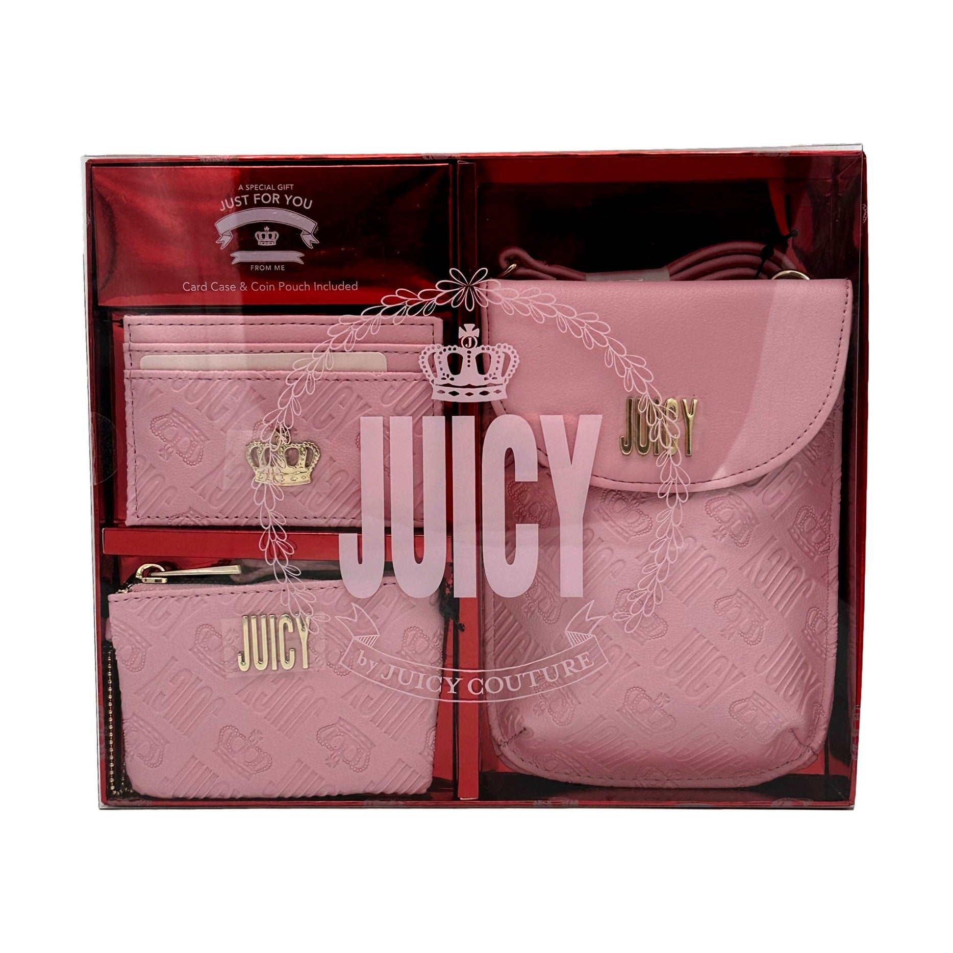 A pink Juicy Couture gift set with a card case, coin pouch, and crossbody bag inside a glossy box.